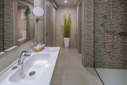 a bathroom with a sink and a shower at Hotel Olympus Palace in Salou