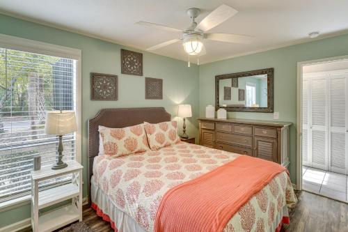 a bedroom with a bed and a mirror and a window at Golf Course Views! Couple's Retreat in Diamondhead in Diamondhead