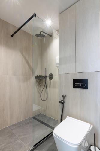 a bathroom with a glass shower with a toilet at Silver Apart in Truskavets