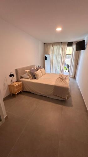 a bedroom with a large bed and a large window at La Tejita "Vida" by BE HAPPY in La Tejita