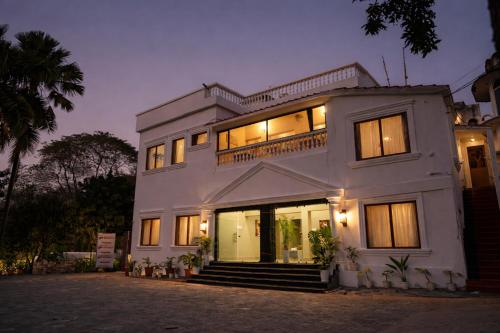 a large white house with lights on at Rajbari Palace in Deoghar