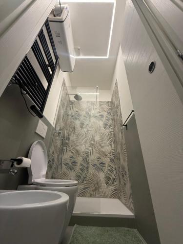 a bathroom with a sink and a toilet in a room at Stay & Solution Apartment in Trieste