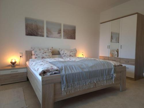 a bedroom with a large bed and a mirror at Ferienwohnung Annenblick in Sankt Wendel