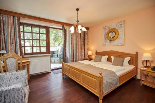 a bedroom with a large bed and a window at Flair-Hotel Neeth in Lehmkuhlen