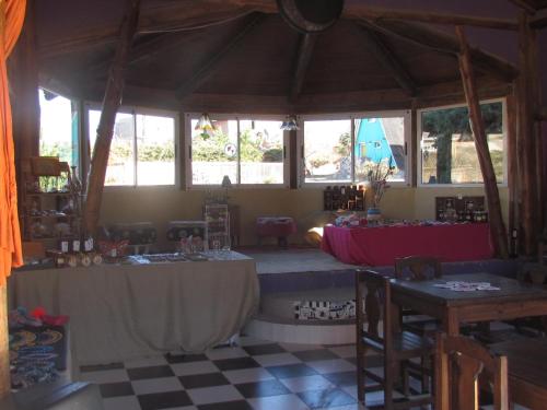 a room with two tables and a table set up at Complejo de Cabañas Tierra de Luna in Potrerillos