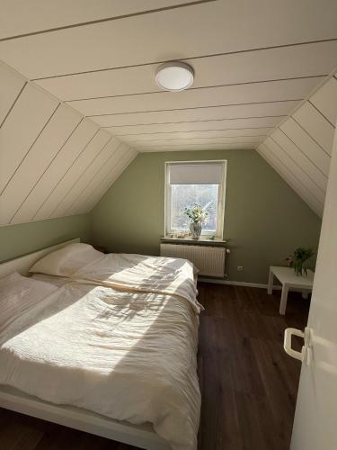 a bedroom with a large bed in a attic at Nordwind Sjut in Warnow