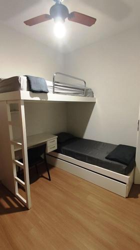 a room with a bunk bed with a ceiling fan at Prince 1513 in Vitória