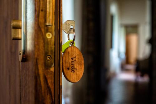 a wooden padlock on a door in a hallway at Tenuta di Montemassi Fattoria in Montemassi
