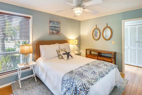 a bedroom with a bed and a window at Golfer's Getaway! Modern Diamondhead Condo in Diamondhead