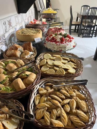 a buffet with many different types of bread and pastries at Hotel Prime Ceaka in Caruaru