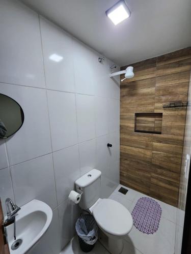 a bathroom with a toilet and a sink at Studio Aconchegante in Lins