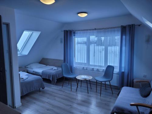 a living room with two chairs and a couch at Nartorama HotRest in Zieleniec