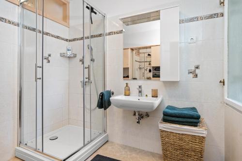 a bathroom with a shower and a sink at Gortanova Bay Maisonette in Pula
