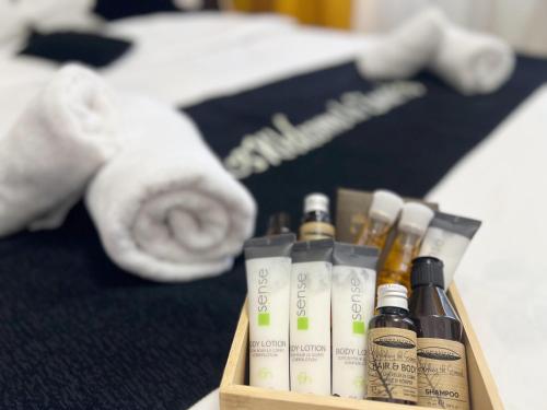 a wooden box with bottles of hair products and a towel at Hotel Zava Boutique - City Center in Bucharest