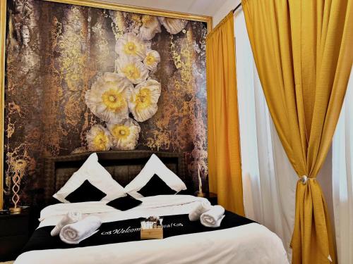 a bedroom with a bed with flowers on the wall at Hotel Zava Boutique - City Center in Bucharest