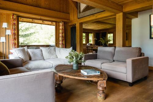 a living room with a couch and a table at L'Alpaga, a Beaumier hotel in Megève