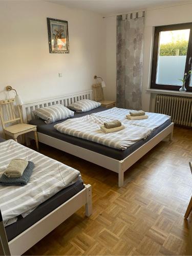 two beds sitting in a room with a window at Reiter- und Ferienhof Redder in Bad Driburg