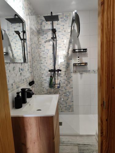 a bathroom with a sink and a shower at Reyes in Monachil
