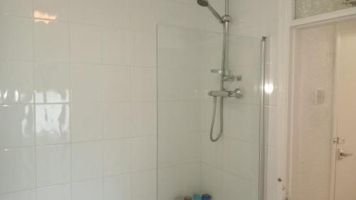 a bathroom with a shower with a glass door at ThinkGlobal Properties Ltd in Stoke on Trent