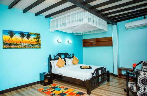 a bedroom with a bed in a blue room at Kijiji Beach Resort in Dar es Salaam