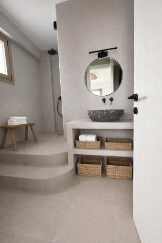 a bathroom with a sink and a mirror at REYA suites in Aliki