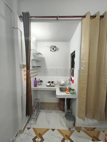 a small bathroom with a sink in a room at Nibha Homestay Near Guwahati Railway station 2BHK in Guwahati
