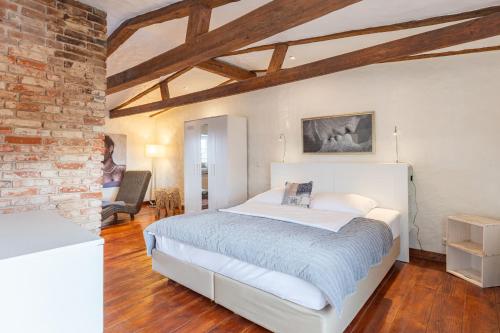 a bedroom with a bed and a brick wall at Lodge an der Muehle in Bredstedt