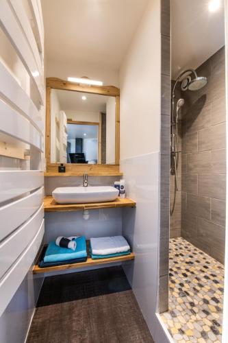 a bathroom with a sink and a mirror at D2 Luxury Chalet Mountain View Sleeps 12 Coffee in Val Thorens