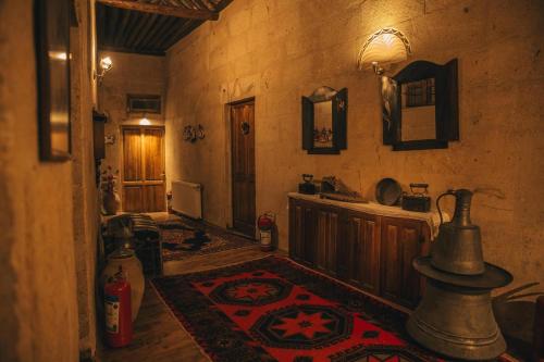 a hallway of a house with a rug on the floor at Temenni Evi Cave Hotel in Ürgüp