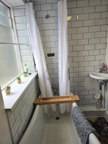a bathroom with a shower and a tub and a sink at Little Dorrit Studio flat Rochester ME1 1XZ in Strood