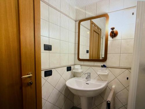 a bathroom with a sink and a mirror at Residenz Fontana mit Pool in San Zeno di Montagna