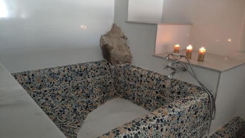a couch in a room with a table and candles at The sea-cave house in Puerto de Mazarrón