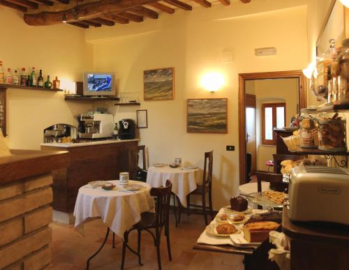 a restaurant with two tables and chairs in a room at Hotel Pallotta in Assisi