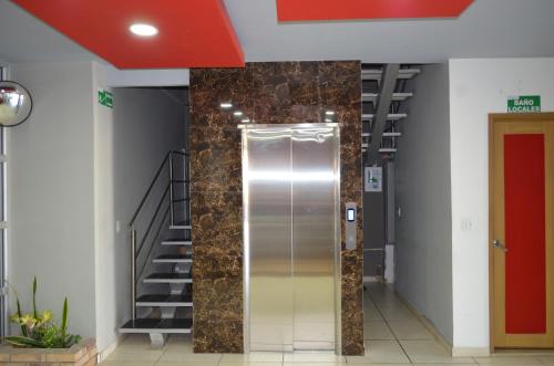 ascensor en un edificio con escalera en Hotel Confort Ariari, en Granada