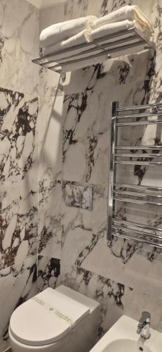 a bathroom with a white toilet and a sink at Hotel V7 in Milan
