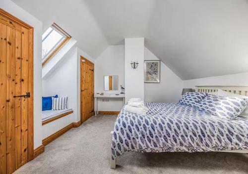 a bedroom with a bed and a window at Charming Family Stables Conversion - Pass the Keys in Emsworth
