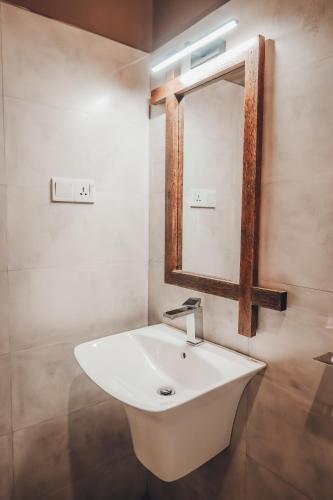 a bathroom with a white sink and a mirror at Secret House in Dickwella
