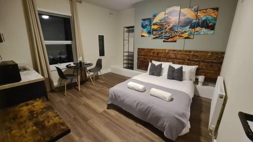 a bedroom with a large white bed and a table at City Stays Norwich in Norwich
