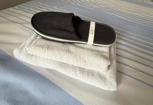 a shoe sitting on a bed with a white towel at Brenzhotel Heidenheim in Heidenheim an der Brenz