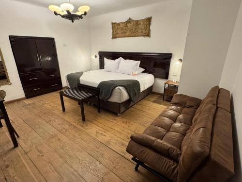 a hotel room with a bed and a couch at Afma Nueva Alta in Cusco