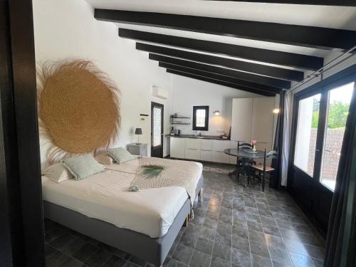 a bedroom with a large bed and a table at Finca Bona Nit in Jávea