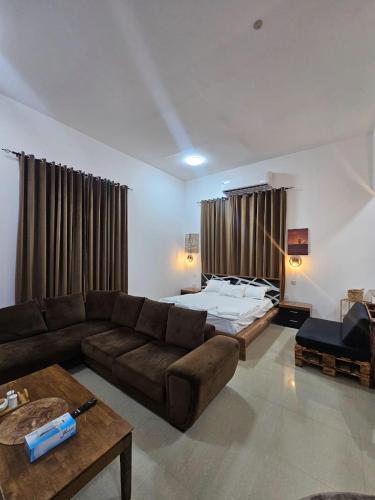 a living room with a couch and a bed at Big studio in Jimi Alain city in Al Ain
