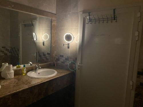 a bathroom with a sink and a mirror at Big studio in Jimi Alain city in Al Ain