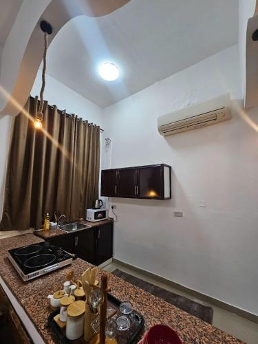 a kitchen with a counter with a sink and a stove at Big studio in Jimi Alain city in Al Ain