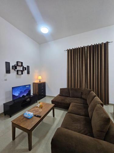 a living room with a couch and a coffee table at Big studio in Jimi Alain city in Al Ain