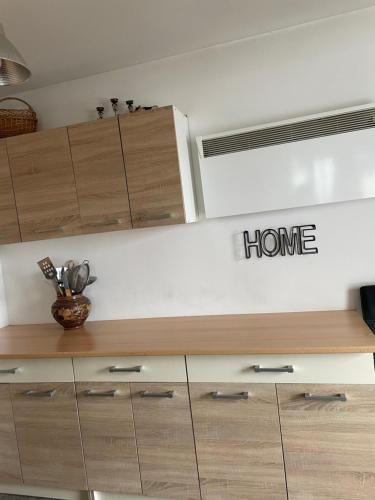 a shelf with a home sign on a wall at Casa Crăciun in Mănăstirea Humorului