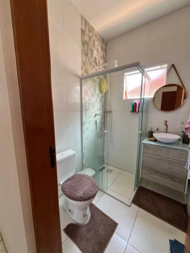 a bathroom with a shower and a toilet and a sink at Casa com Piscina em Jarinu in Jarinu