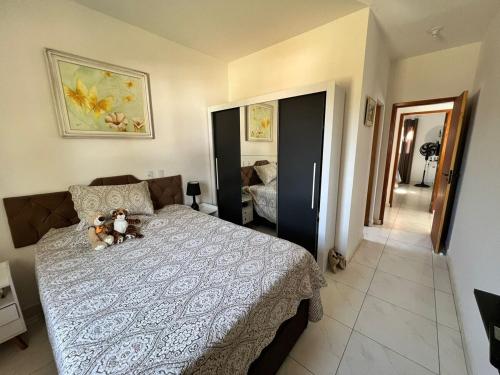 a bedroom with a bed with two teddy bears on it at Casa com Piscina em Jarinu in Jarinu