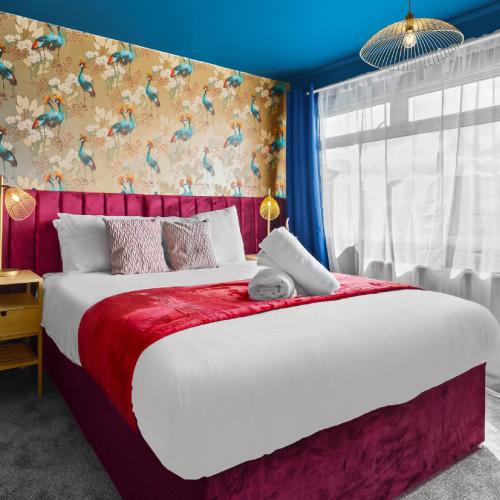 a bedroom with a large bed with a red blanket at Stylish 3 Bedroom House - King Size Beds - 5 Guests - Garden & Parking 4VC in Minworth