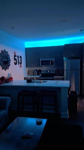 a kitchen with a blue lighting in a room at The 513 Flat! 1BR, 1Bath Apt with Pool and Riverfront View! Free Gated Parking! Only Steps from The banks & Stadiums! in Cincinnati